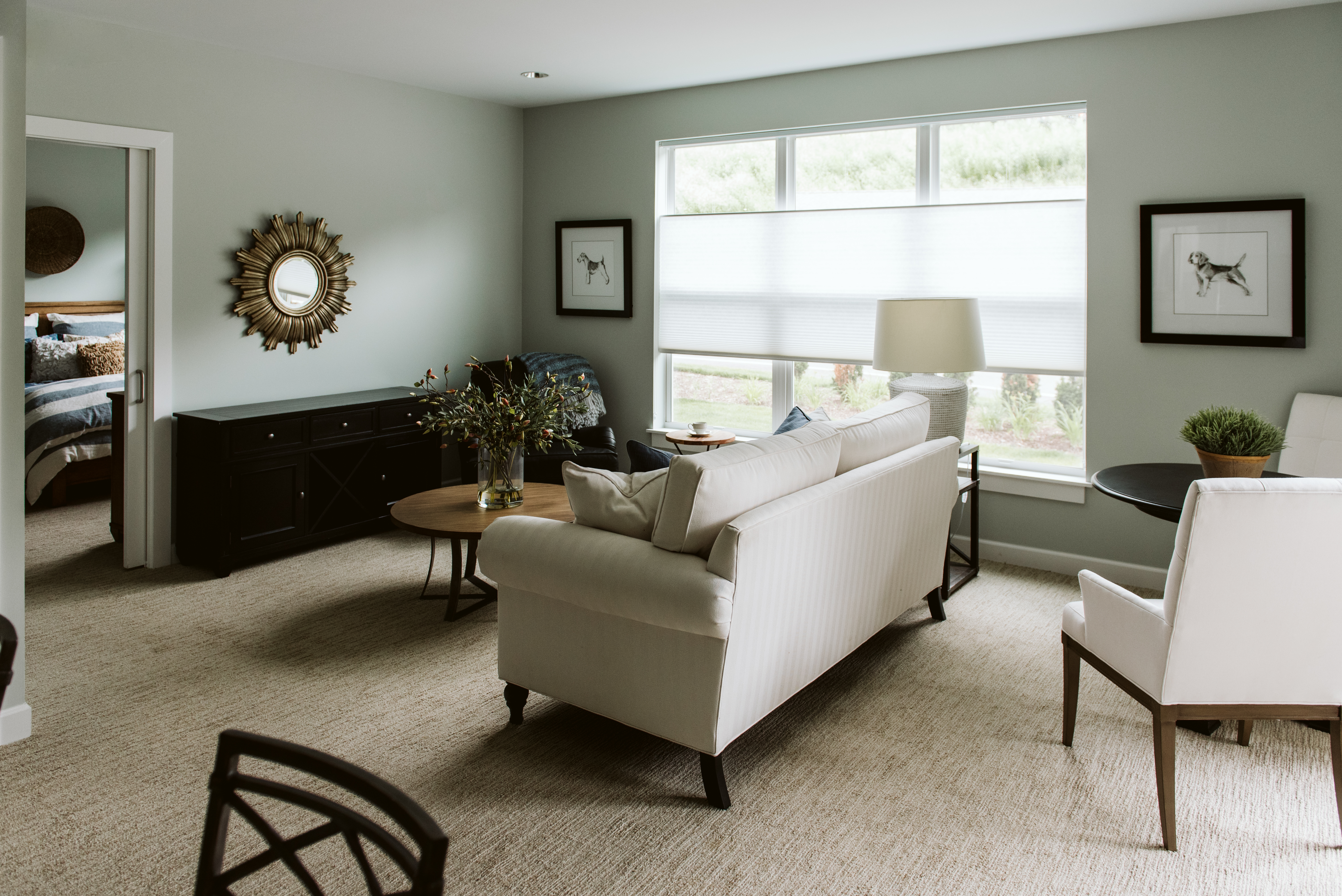 A carpeted apartment living room with a couch